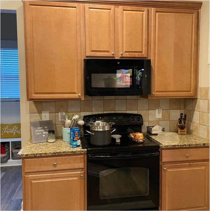 Honey oak kitchen cabinets before Carolina Superior Painting refinished them