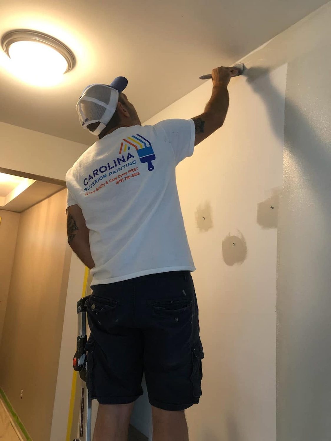 A Carolina Superior Painting painter filling and smoothing a wall