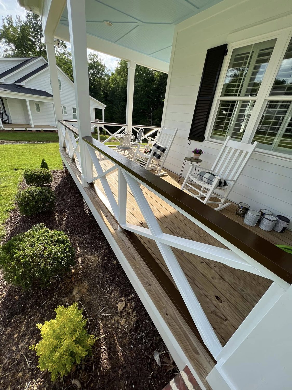 Porch rail and columns in white by Carolina Superior Painting LLC