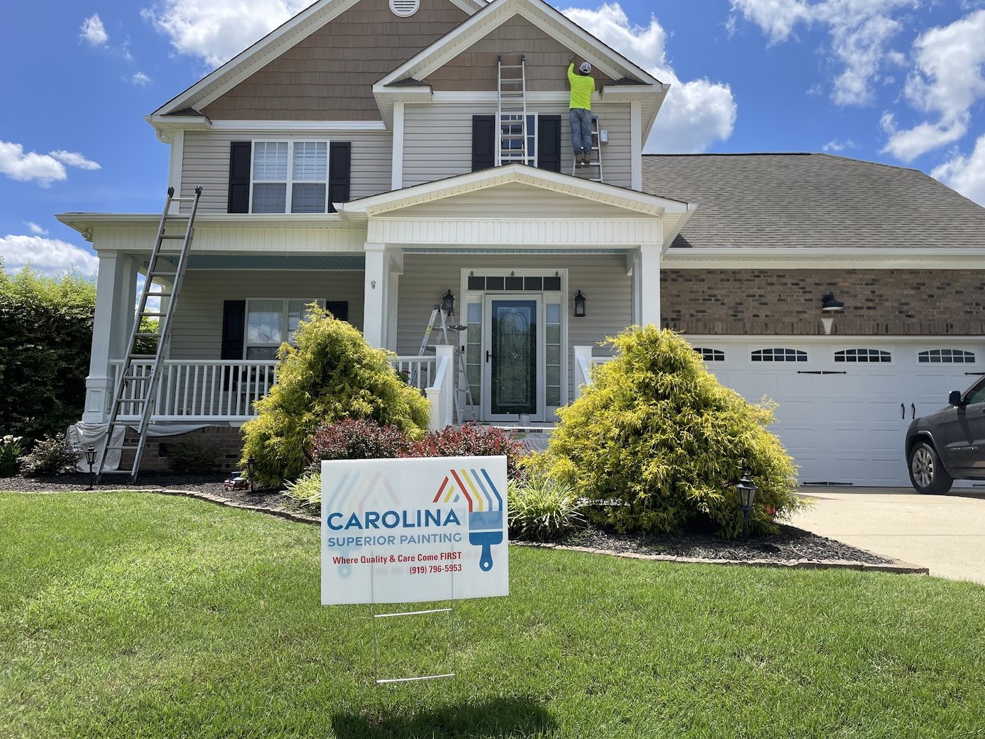 A full exterior repaint, the sign still in the yard by Carolina Superior Painting LLC