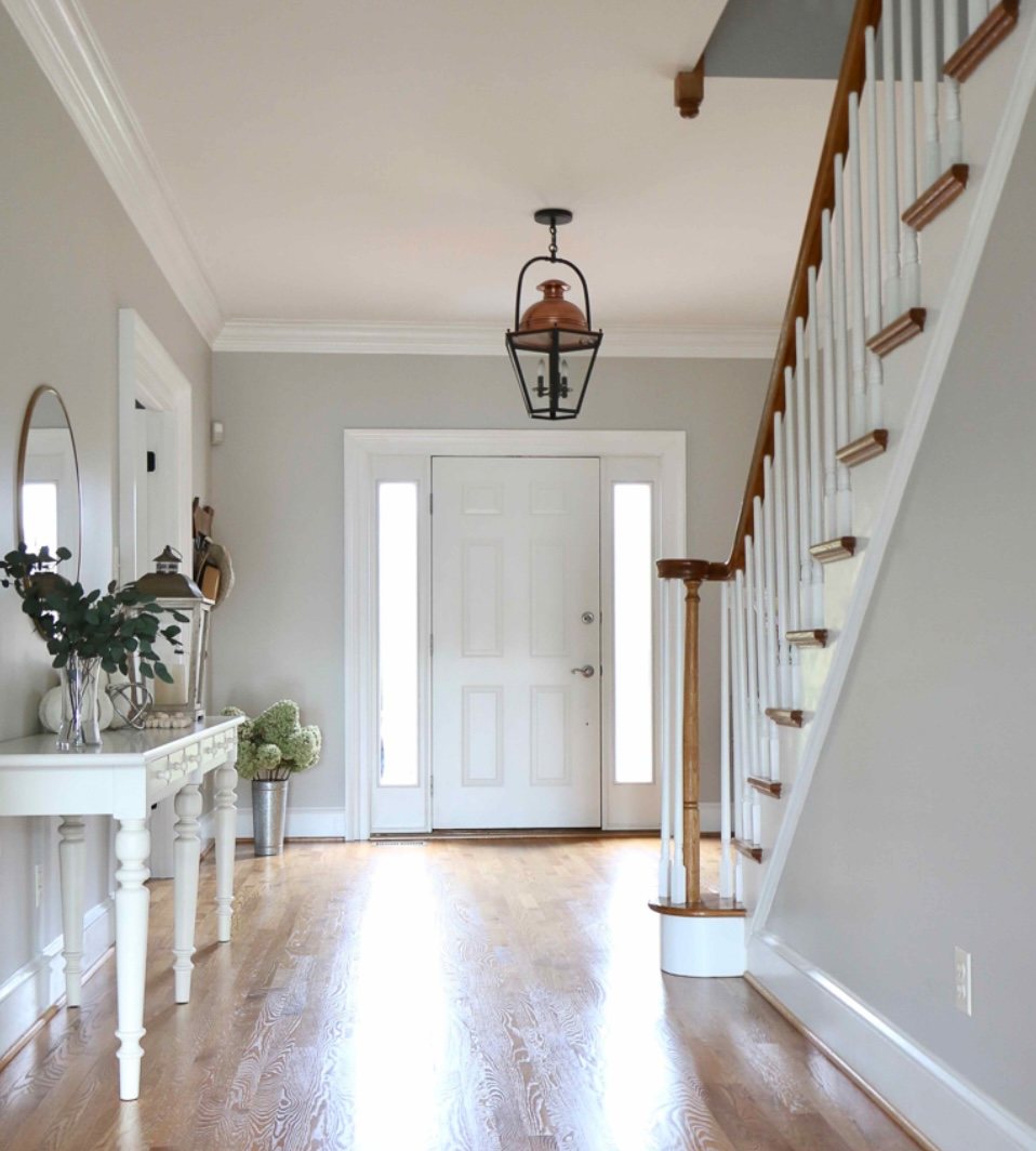 Entry, stair rail and trim painted crisp white by Carolina Superior Painting LLC